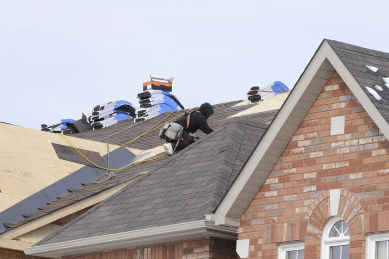 roofer installing new asphalt shingles